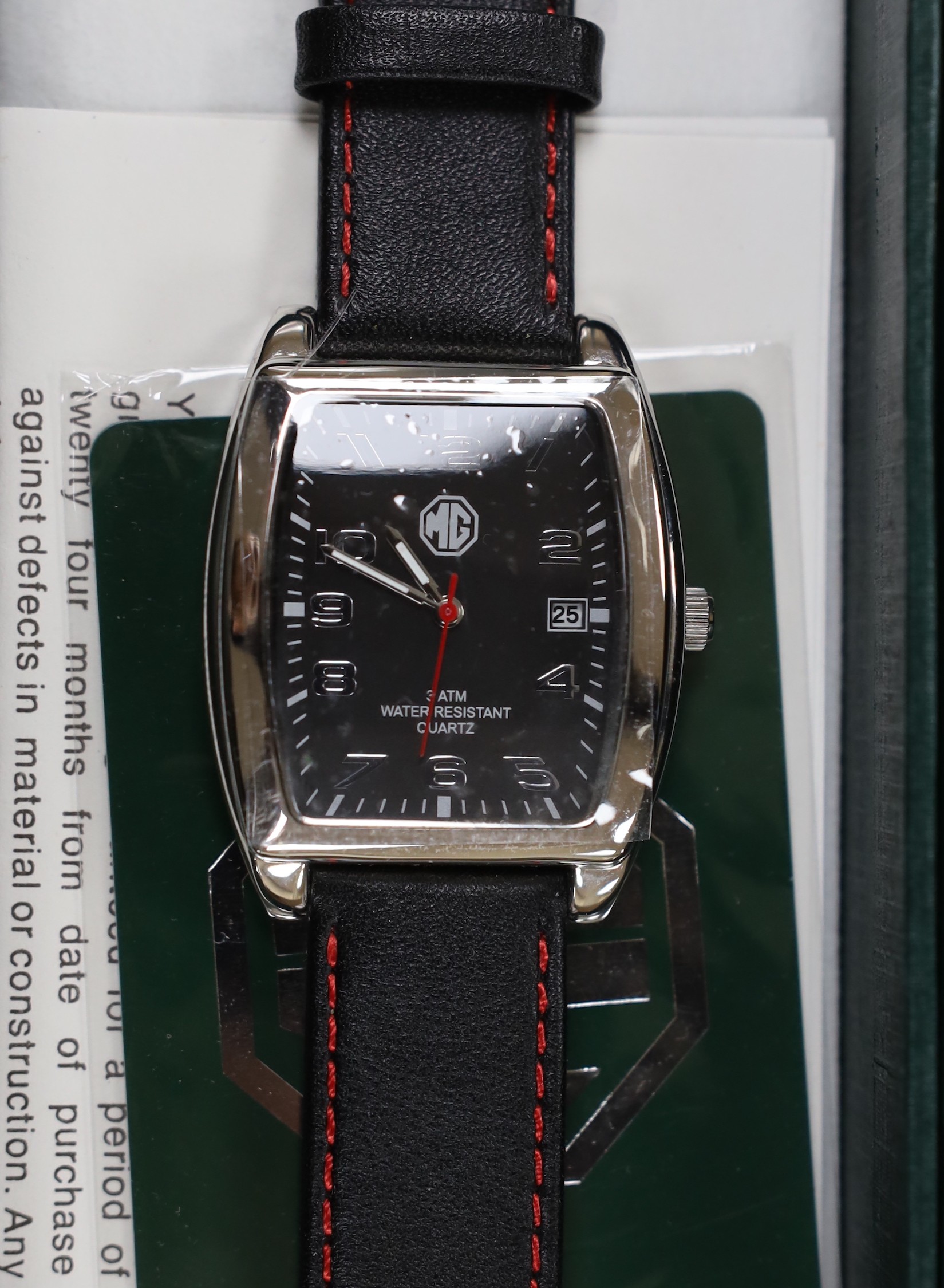 A gentleman's modern stainless steel Delorean automatic calendar wrist watch, with red face and three subsidiary dials, together with three assorted modern MG motors quartz wrist watches.